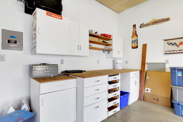 6610 S Springview St, Spokane, WA 99224 - kitchen featuring butcher block countertops, open shelves, white cabinets, and concrete flooring