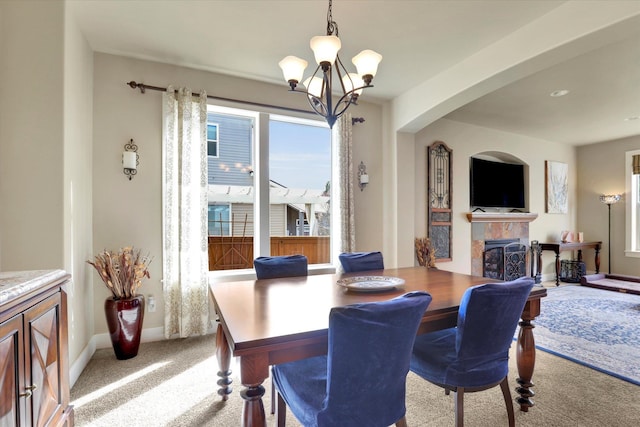 6610 S Springview St, Spokane, WA 99224 - dining space with a chandelier, carpet, and a tile fireplace