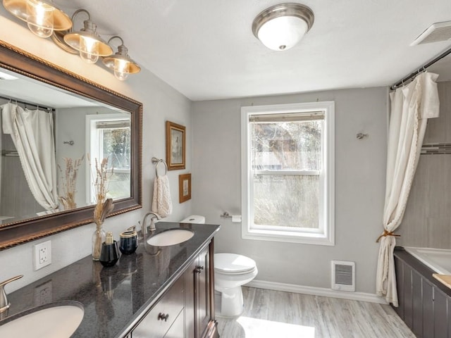bathroom with a sink, visible vents, and a healthy amount of sunlight