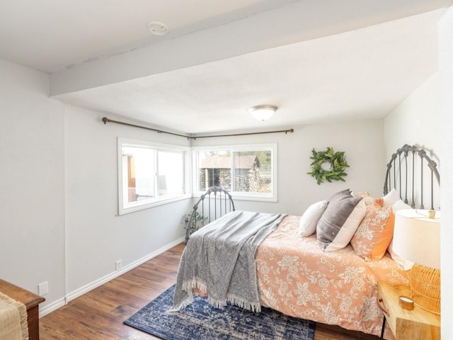 bedroom featuring wood finished floors and baseboards