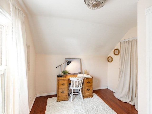 office space with baseboards, vaulted ceiling, and wood finished floors