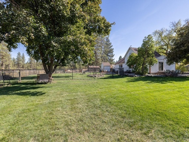 view of yard with entry steps and fence