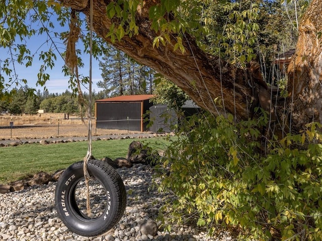 view of yard with an outbuilding and fence