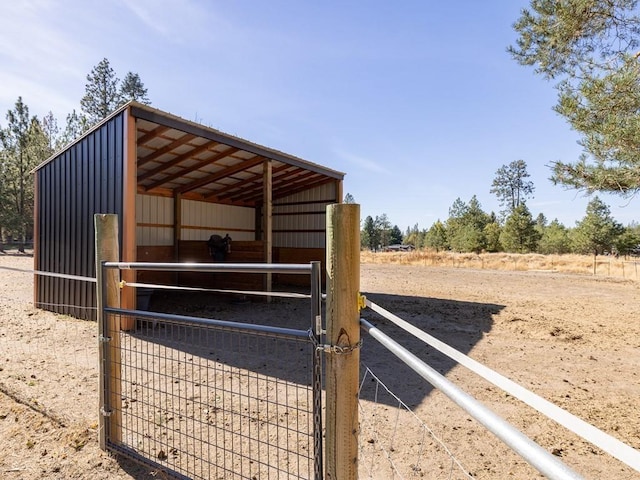 view of horse barn with a rural view