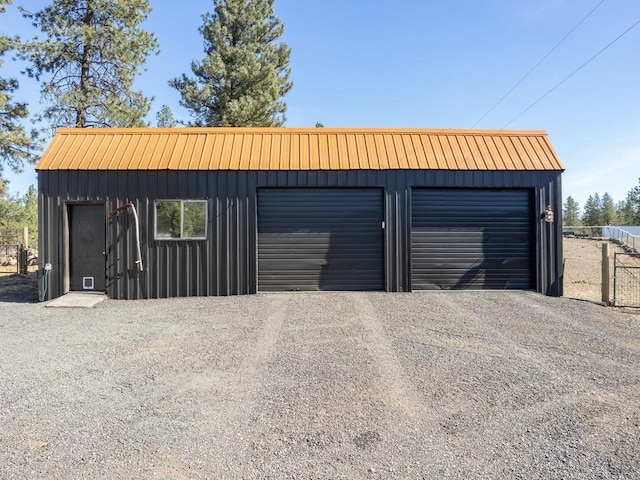 detached garage featuring fence