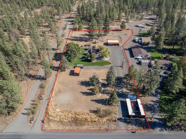 drone / aerial view with a wooded view
