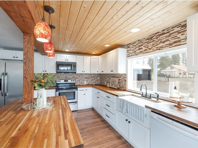 kitchen featuring wood counters, wood ceiling, a sink, and appliances with stainless steel finishes