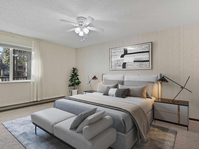 carpeted bedroom with baseboards, a baseboard radiator, a textured ceiling, and a ceiling fan
