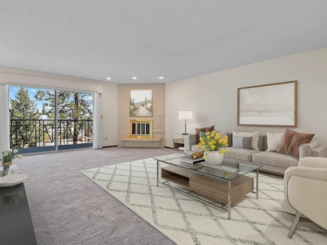 carpeted living room with a large fireplace and recessed lighting