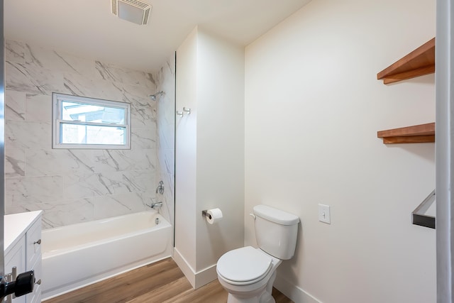 bathroom featuring bathing tub / shower combination, vanity, visible vents, toilet, and wood finished floors
