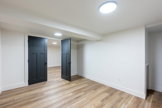 finished below grade area featuring recessed lighting, light wood-style floors, and baseboards