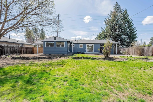 back of house featuring a patio, fence, and a lawn