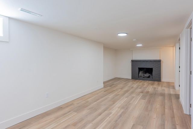 unfurnished living room featuring light wood-style floors, a fireplace, visible vents, recessed lighting, and baseboards