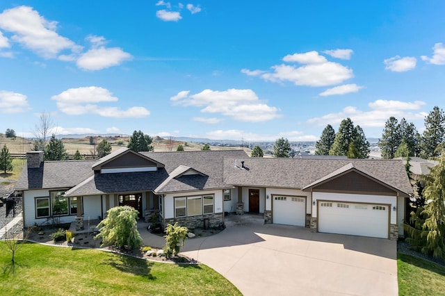 view of front of property with a garage, roof with shingles, stone siding, a front lawn, and concrete driveway