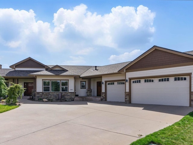 craftsman house featuring a shingled roof, driveway, a garage, and stone siding