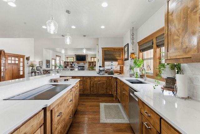 kitchen with recessed lighting, dark wood-style flooring, dishwasher, a sink, and black electric stovetop