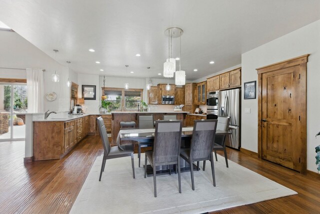 dining area featuring dark wood-type flooring, recessed lighting, and plenty of natural light