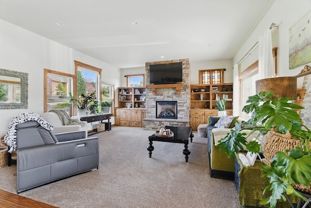 living area featuring a fireplace and carpet