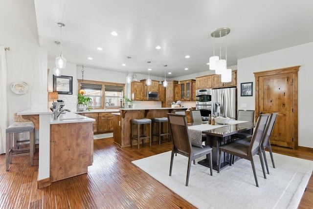 dining room with recessed lighting and wood finished floors