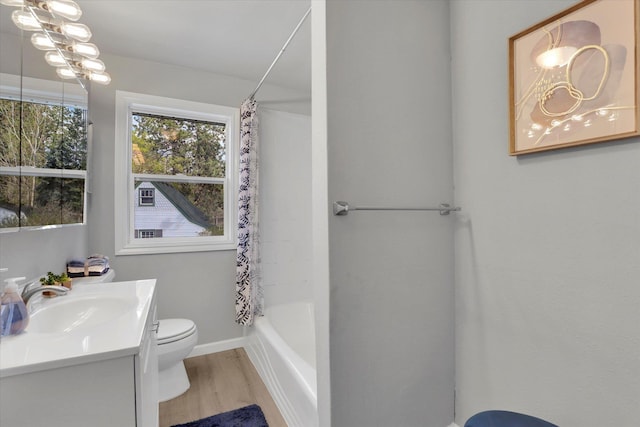 full bathroom with a notable chandelier, toilet, shower / tub combo with curtain, vanity, and wood finished floors