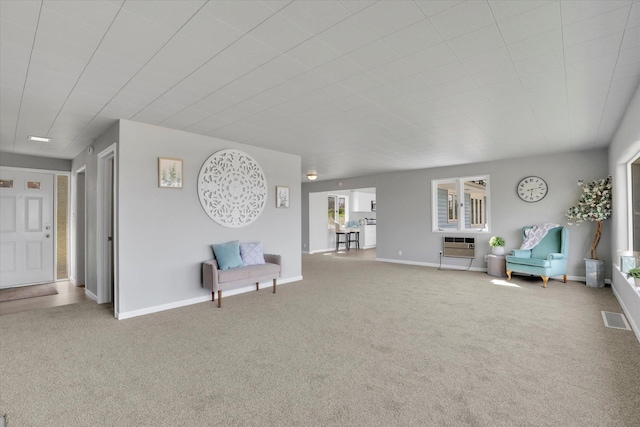 living area featuring baseboards, carpet, visible vents, and heating unit