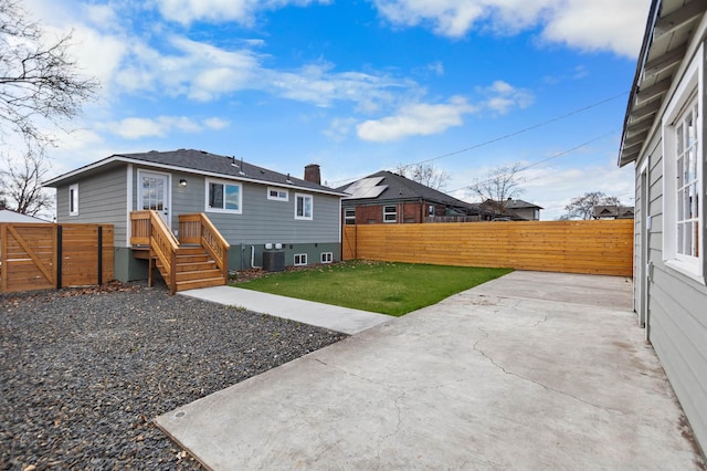 703 E Kiernan Ave, Spokane, WA 99207 - back of property featuring a patio area, a fenced backyard, a yard, and central AC