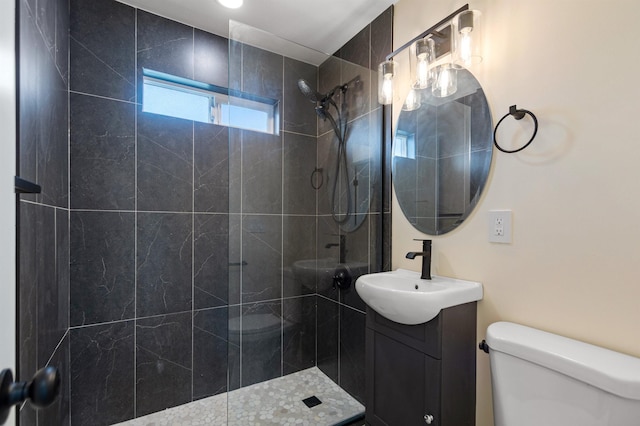 703 E Kiernan Ave, Spokane, WA 99207 - bathroom featuring a tile shower, vanity, and toilet