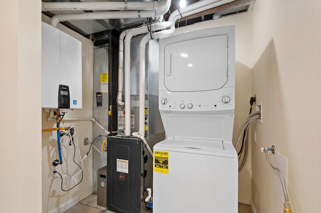 703 E Kiernan Ave, Spokane, WA 99207 - washroom with water heater, stacked washer and clothes dryer, and laundry area