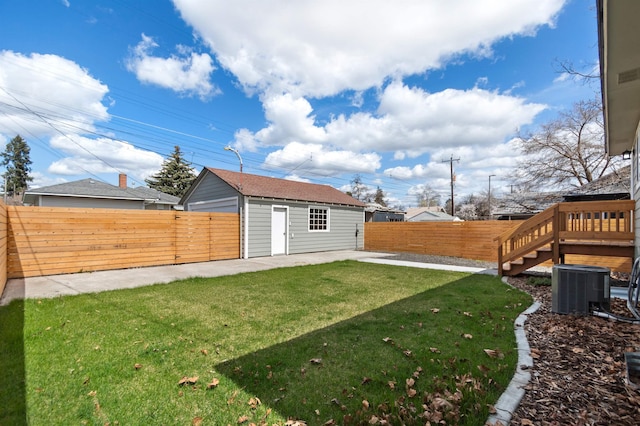703 E Kiernan Ave, Spokane, WA 99207 - view of yard featuring a fenced backyard, an outbuilding, cooling unit, and a patio