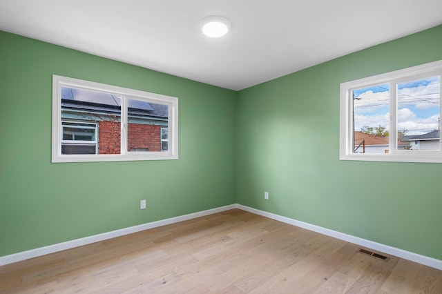 703 E Kiernan Ave, Spokane, WA 99207 - spare room featuring visible vents, baseboards, and light wood-style floors