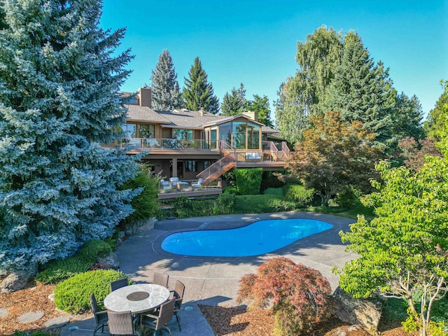 7816 E Gunning Ln, Spokane, WA 99212 - outdoor pool with stairs, a wooden deck, a patio, and a sunroom