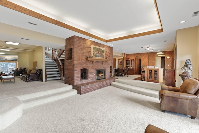 7816 E Gunning Ln, Spokane, WA 99212 - carpeted living area with stairway, a fireplace, wood walls, and recessed lighting