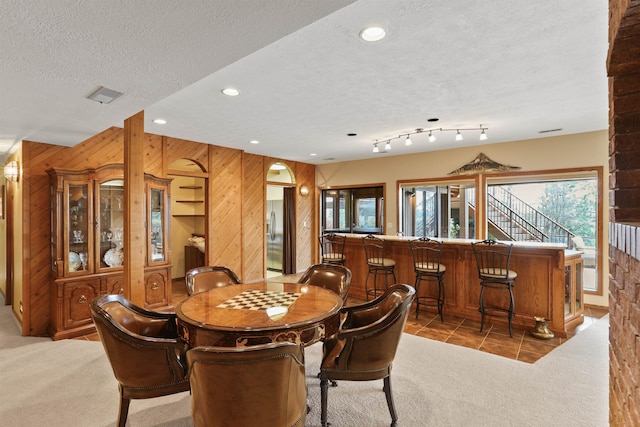 7816 E Gunning Ln, Spokane, WA 99212 - dining room featuring wooden walls, light carpet, a textured ceiling, recessed lighting, and light tile patterned flooring