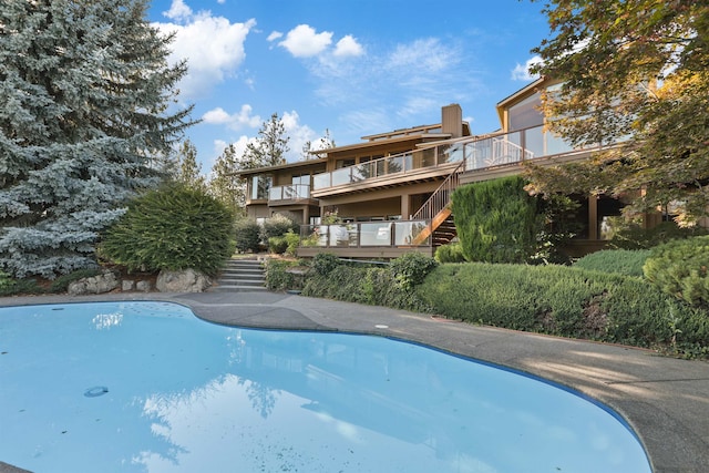 7816 E Gunning Ln, Spokane, WA 99212 - outdoor pool featuring stairway and a deck