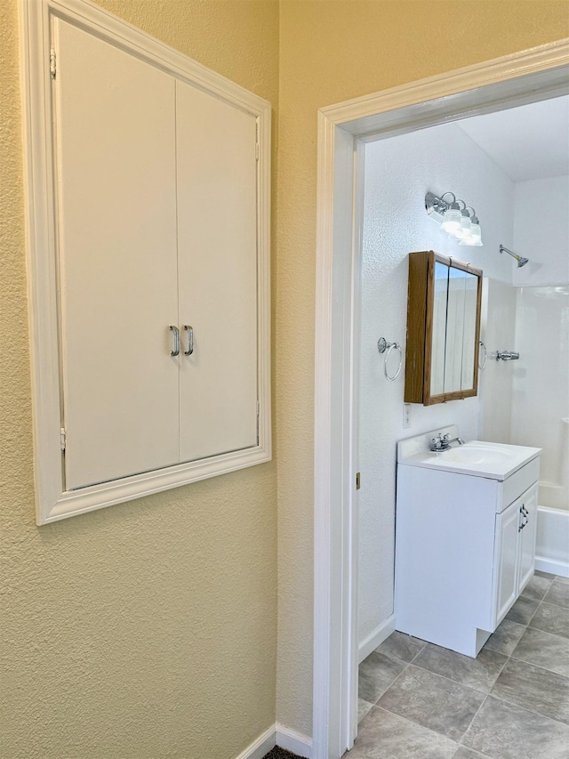 bathroom featuring baseboards and vanity