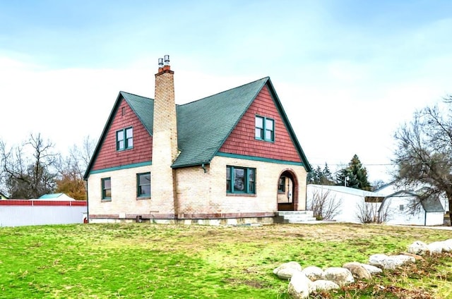 2612 N Elizabeth Rd, Spokane Valley, WA 99212 - back of house with a chimney, brick siding, fence, and a lawn