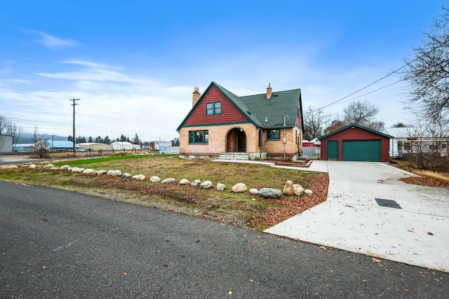 2612 N Elizabeth Rd, Spokane Valley, WA 99212 - tudor-style house featuring an outbuilding, driveway, a garage, and a chimney