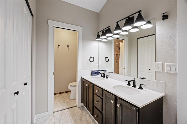 619 W Persimmon Ln, Spokane, WA 99224 - bathroom with toilet, double vanity, marble finish floor, and a sink