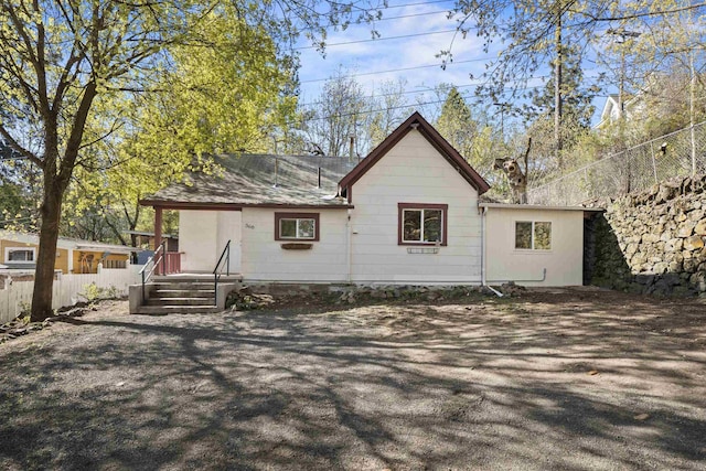 back of house featuring fence