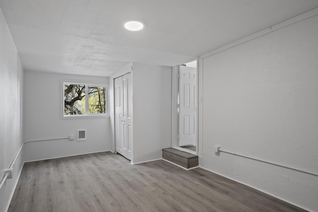 interior space with baseboards and wood finished floors