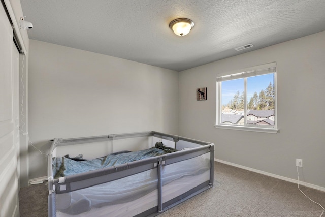 7407 E Beverly Ave, Spokane Valley, WA 99212 - bedroom featuring baseboards, carpet, and a textured ceiling