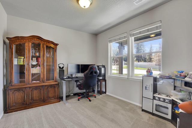 office space featuring light colored carpet and baseboards