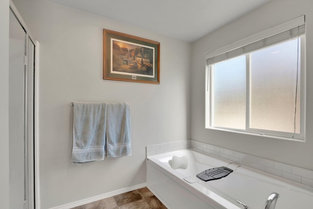 7407 E Beverly Ave, Spokane Valley, WA 99212 - bathroom with healthy amount of natural light, a garden tub, and baseboards