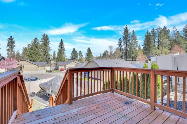 deck featuring fence and a residential view