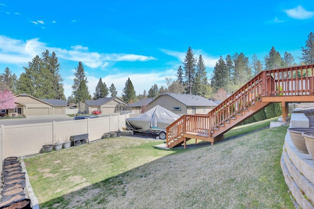 view of yard featuring stairs, a deck, and a residential view