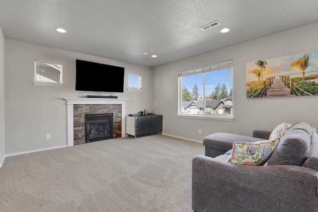 7407 E Beverly Ave, Spokane Valley, WA 99212 - living room featuring baseboards, light colored carpet, a fireplace, recessed lighting, and a textured ceiling