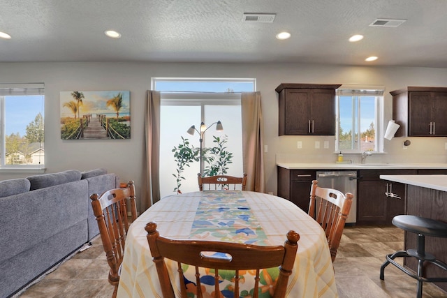 dining area featuring healthy amount of natural light, recessed lighting, and a textured ceiling