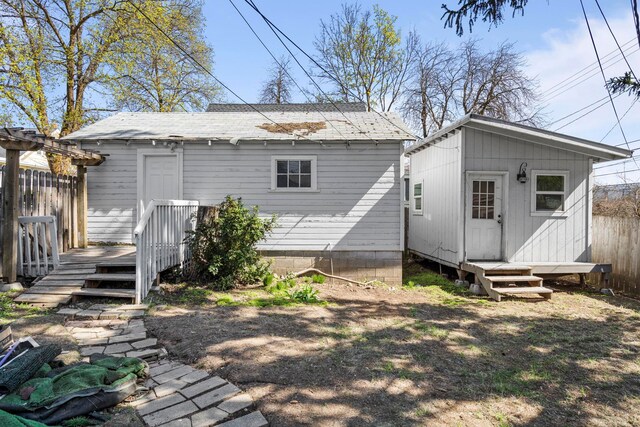 219 F St, Cheney, WA 99004 - back of property featuring fence, a deck, and an outdoor structure