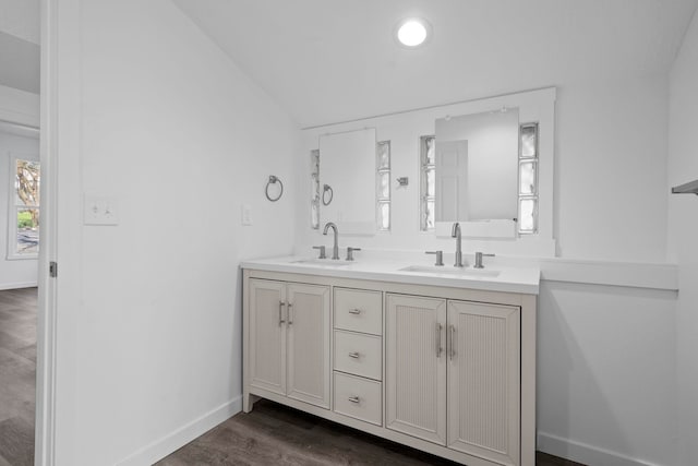 219 F St, Cheney, WA 99004 - full bath featuring vaulted ceiling, double vanity, wood finished floors, and baseboards