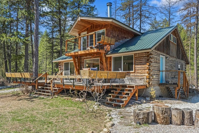 4167 Grouse Creek Rd, Loon Lake, WA 99148 - back of property with a standing seam roof, log siding, metal roof, and a wooden deck